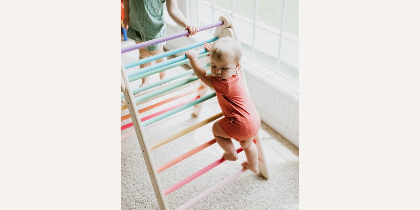 The 6 best Pikler triangles that build gross motor skills while having fun baby climbing on a Pikler triangle - Best Pikler triangles